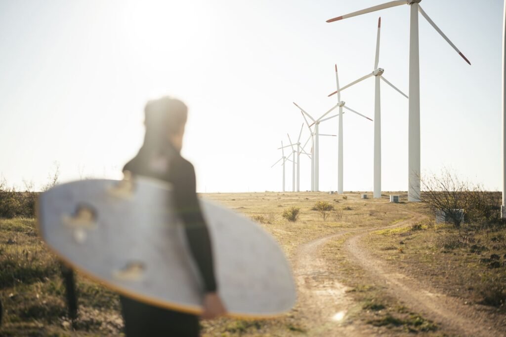 Portugal surfer in front of wind turbines