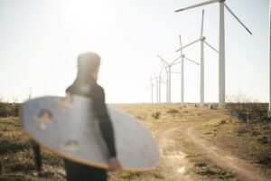 Portugal surfer in front of wind turbines
